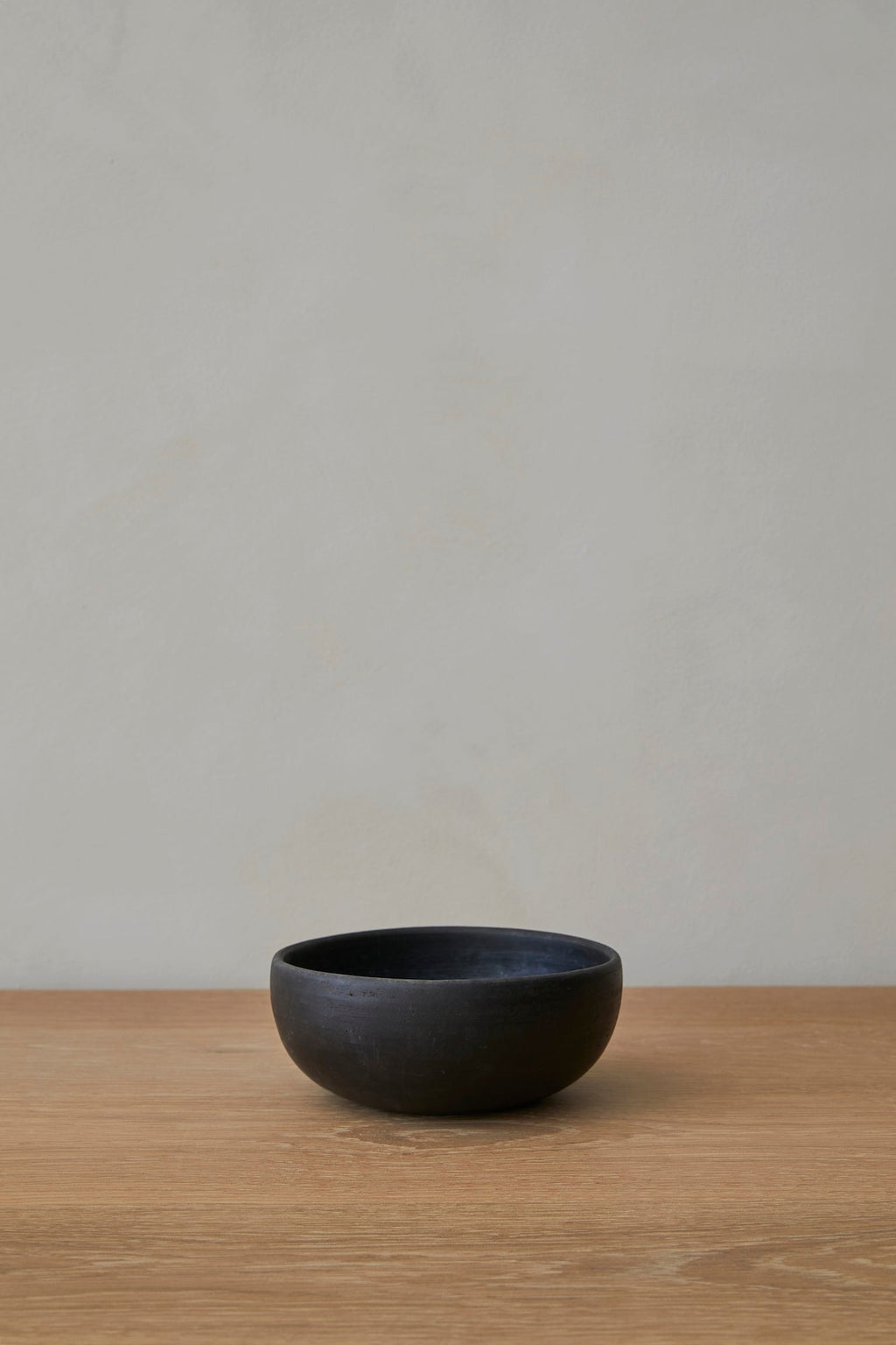 Black Oaxacan handmade ceramic bowl with curved organic shape and rustic texture