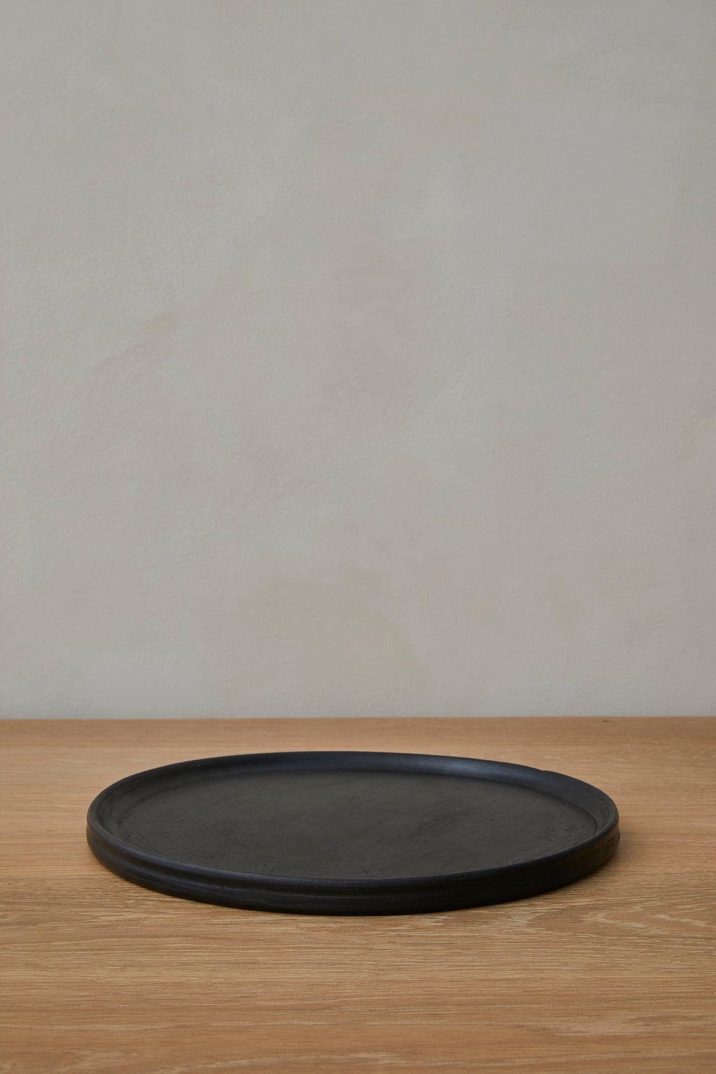 Oaxacan Handmade Ceramic black dinner plate with rustic texture and curved design