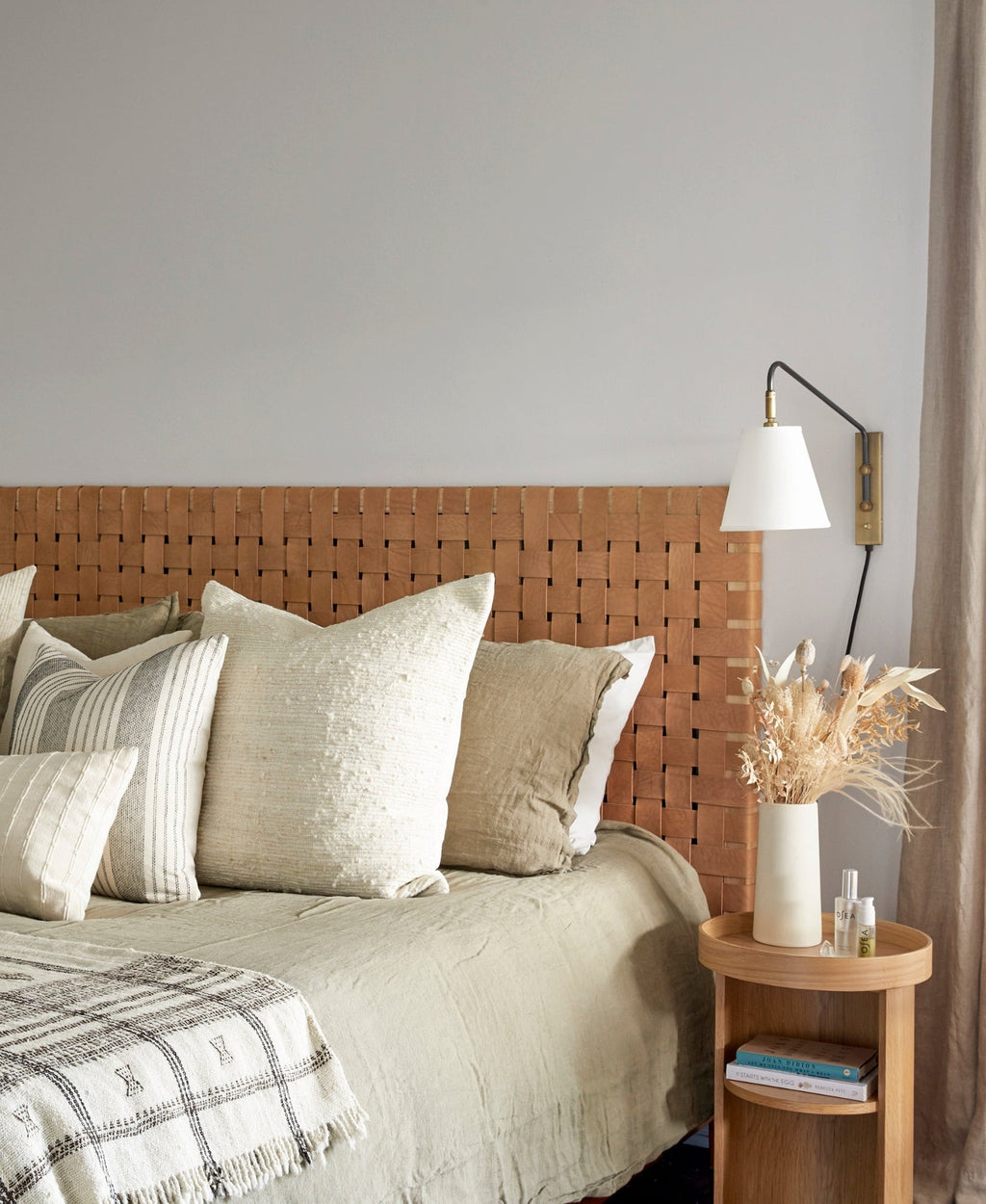 Beige woven leather strap headboard with hand-carved teak frame in natural matte finish