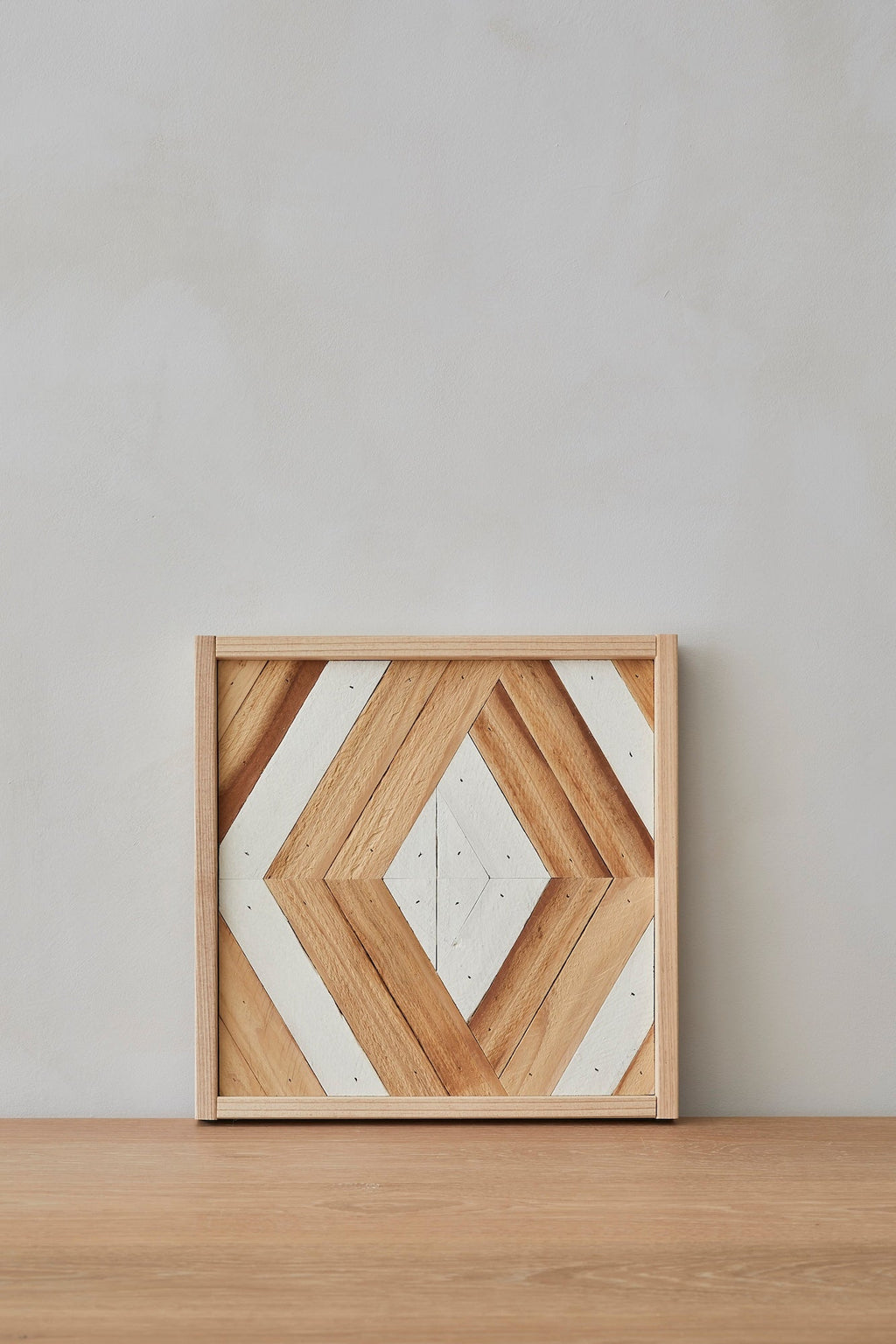 Geometric wood art piece featuring neutral tones and minimalist design inspired by high desert landscapes