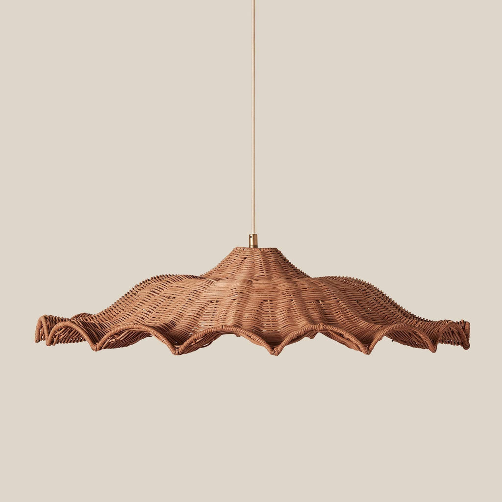 A Savannah large woven wicker pendant light with a wide, scalloped shade suspended by a thin cord against a solid beige background.