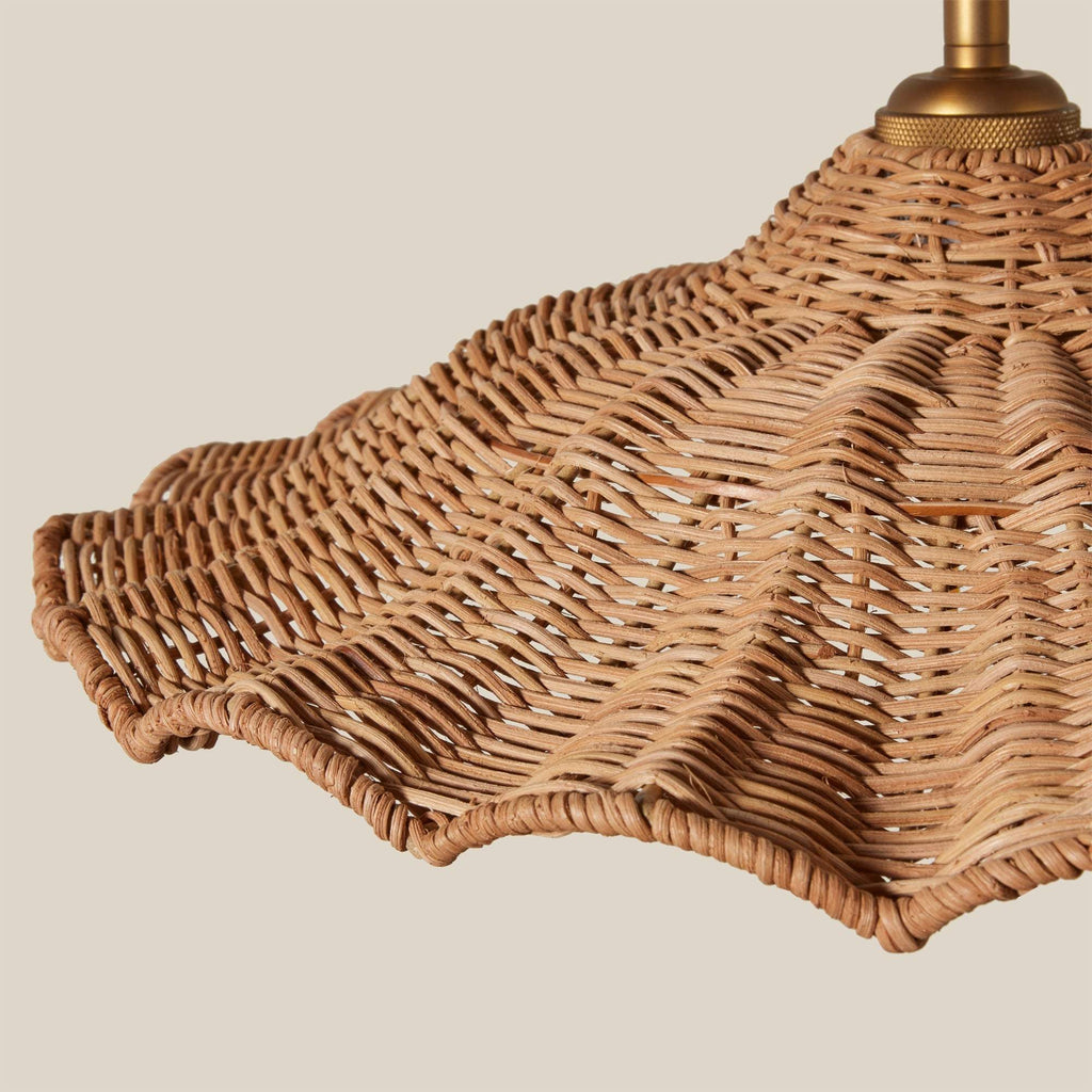 Wicker Savanah lampshade with brass fixture on a beige background