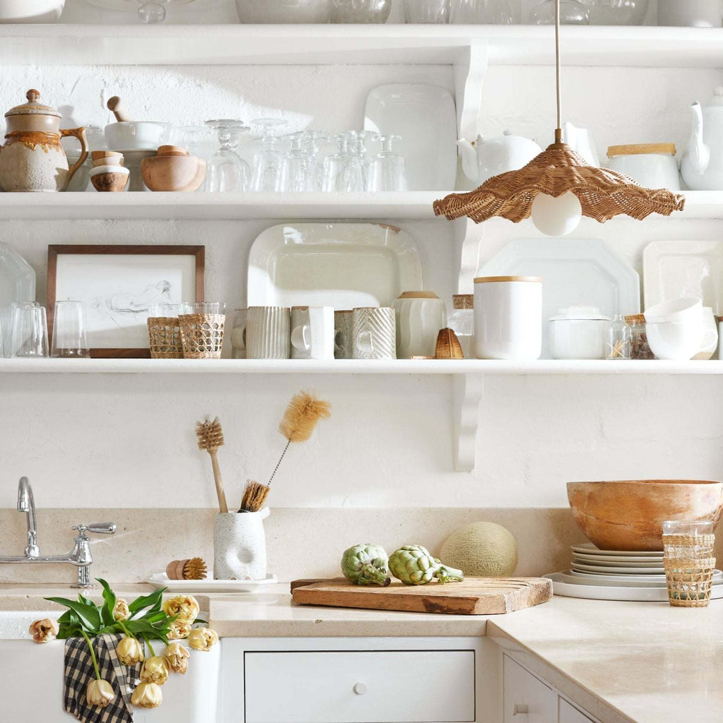 Woven Savannah Pendant in a timeless kitchen with open shelves displaying various kitchenware and decor items.