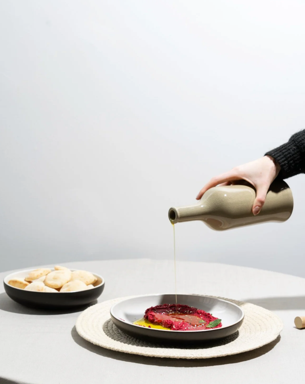 Handcrafted stoneware olive oil dispenser with matte glaze inspired by Tunisian artisanship