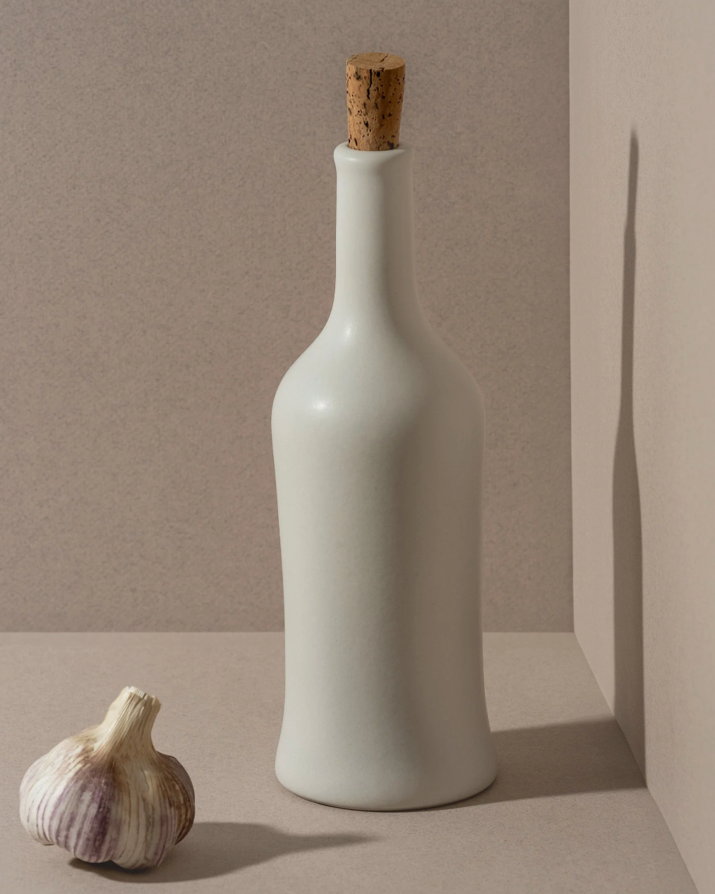 Handcrafted stoneware olive oil dispenser with soft matte glaze inspired by Tunisian artisans