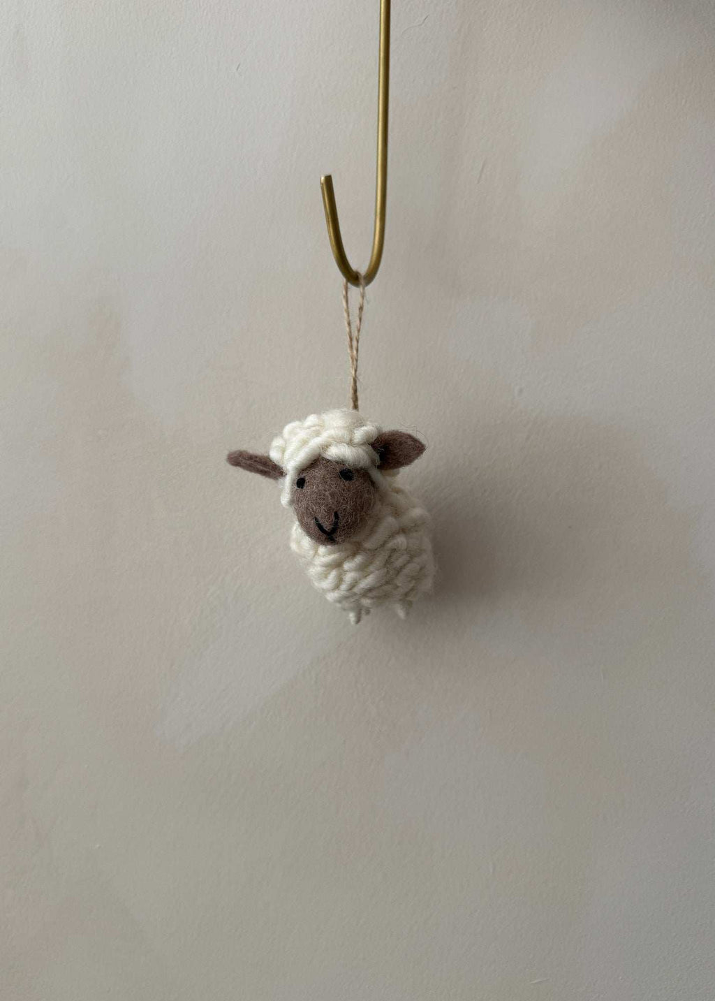 Hand-stitched felt sheep ornament made from high-quality wool for cozy decor