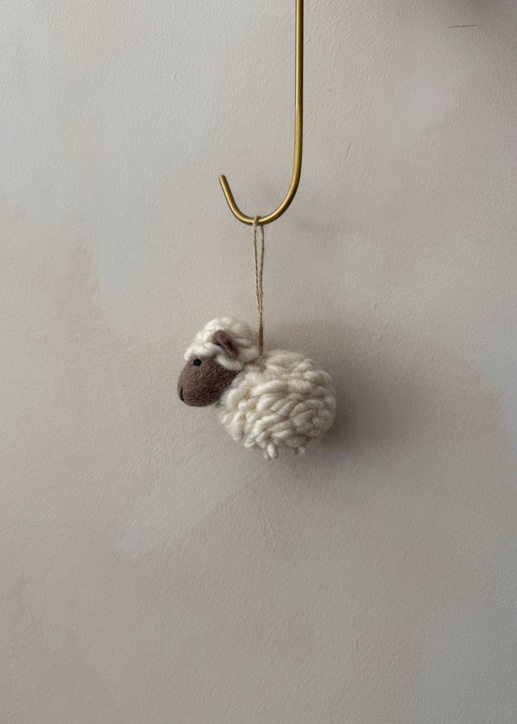 Hand-stitched felt sheep ornament made from high-quality wool with needle-felting, perfect cozy countryside decoration.