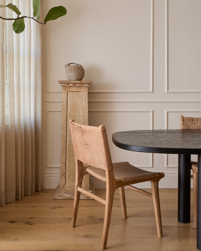 Smooth Leather and Teak Sofia Dining Chair with back in dining room with black dining table and white oak floor. Saffron and Poe