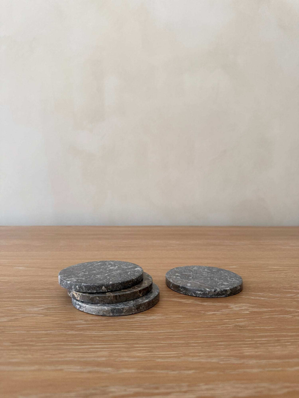 Set of 4 grey stone coasters with unique marble veining and texture