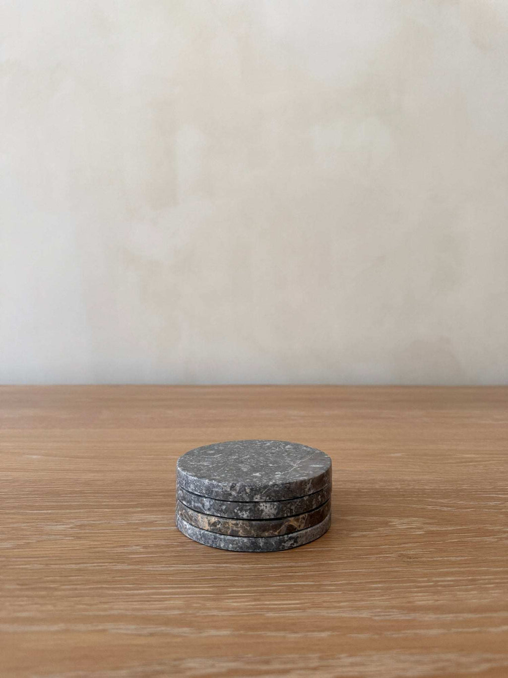 Set of 4 grey stone coasters with natural marble veining, durable and elegant table accents