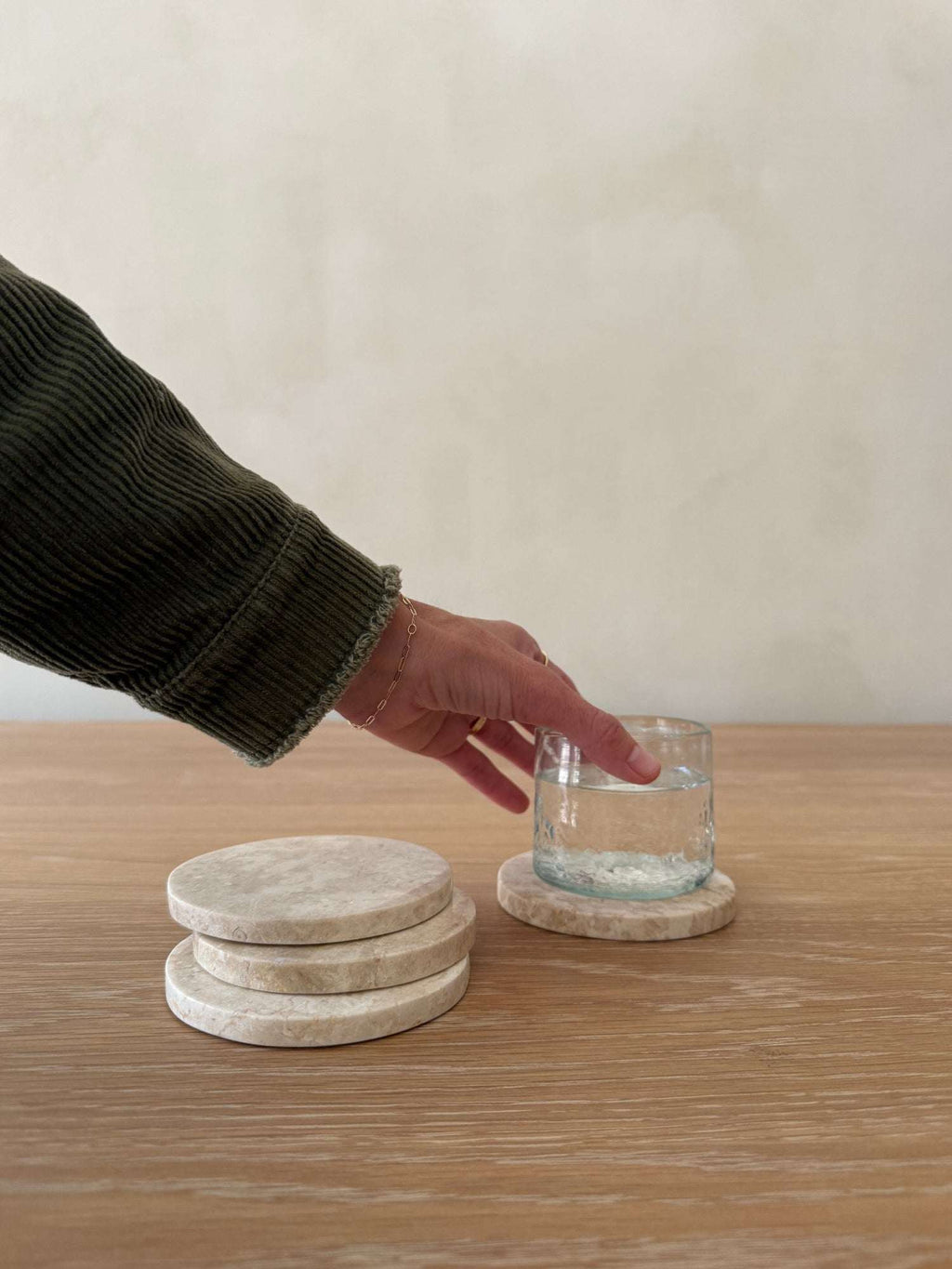 Set of 4 ivory stone coasters with natural marble veining and texture