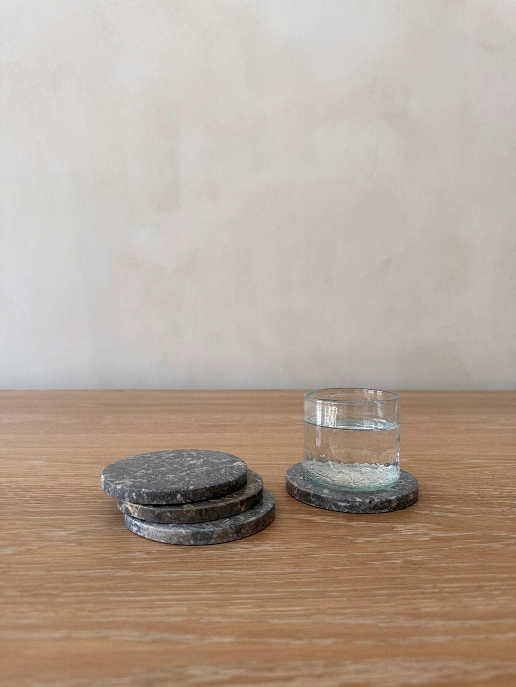Set of 4 grey stone coasters with unique marble veining and texture