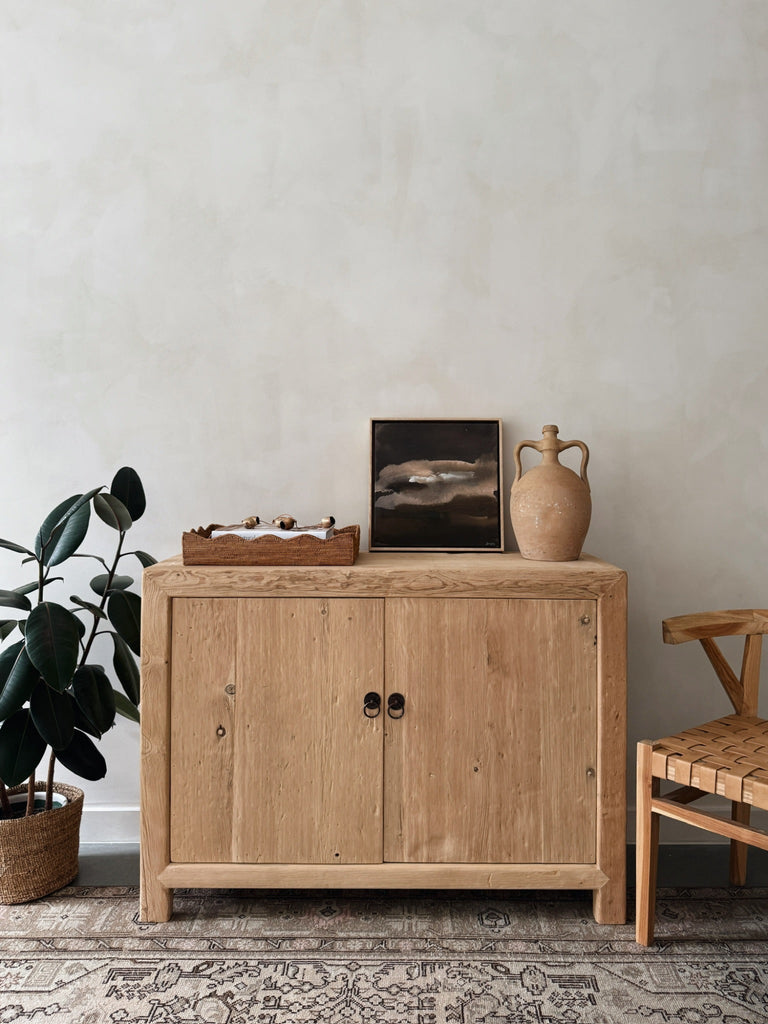 Strata hand-painting by Jaime Lovejoy styled on vintage wood cabinet against lime washed wall. Saffron + Poe