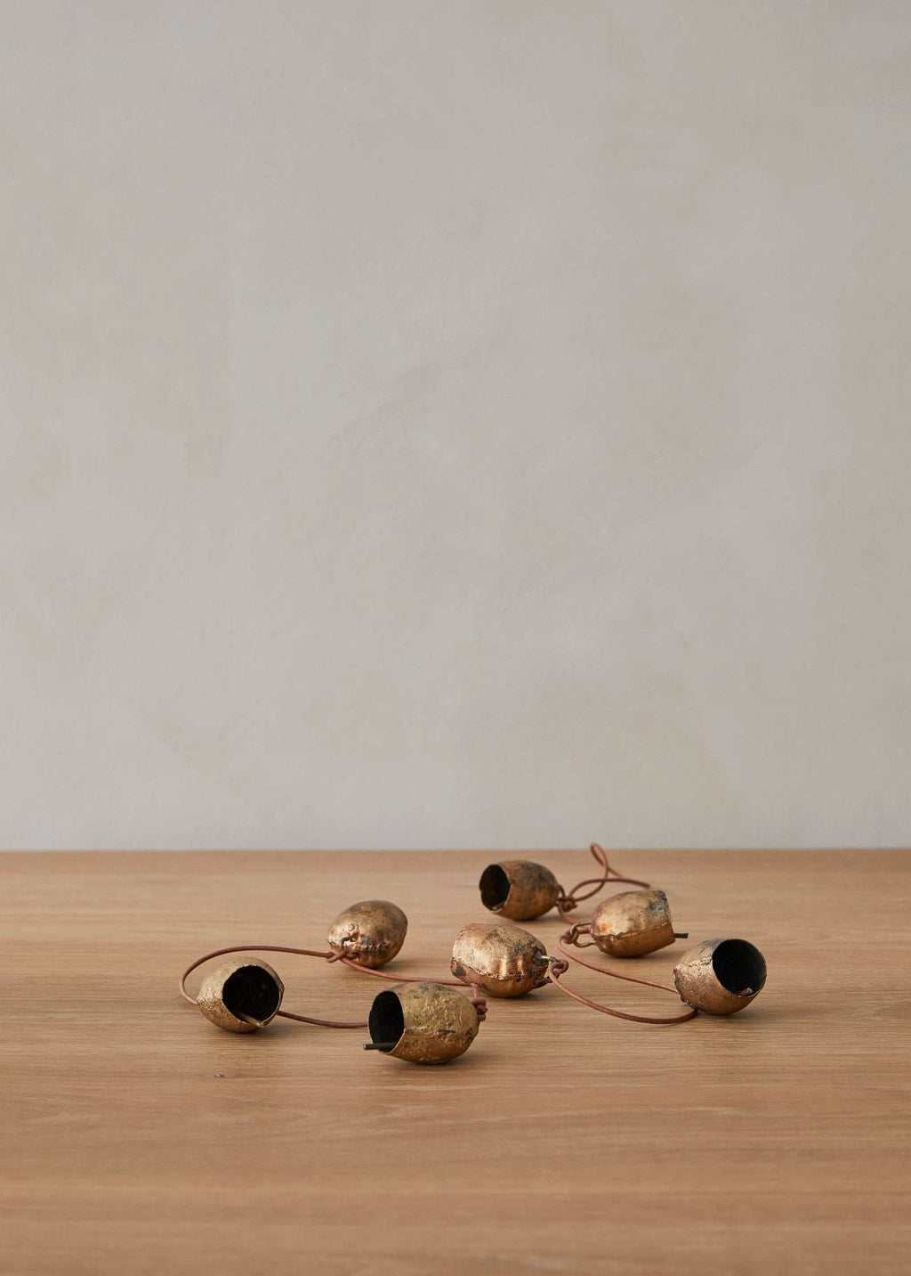 Handcrafted vintage string of bells on leather cord for timeless home decor