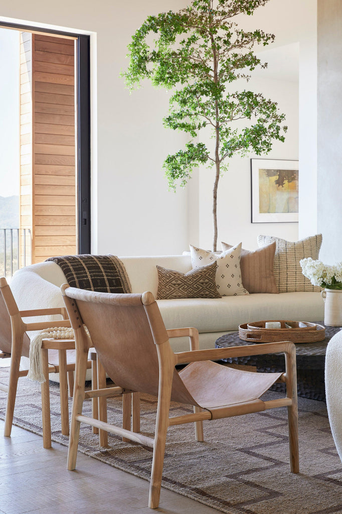 Styled back angle of Leather Sling Lounge chairs in a neutral living room.  - Saffron and Poe