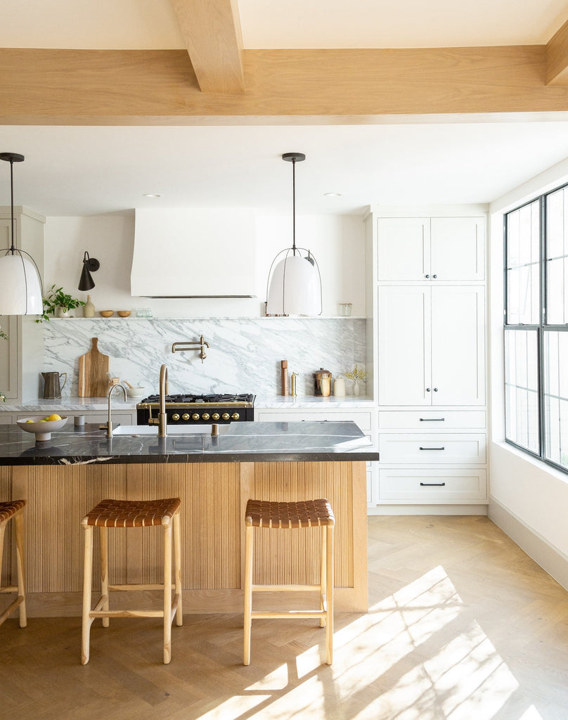 Styled Backless Woven Leather Counter Stool - Saddle in an open and bright kitchen. - Saffron and Poe