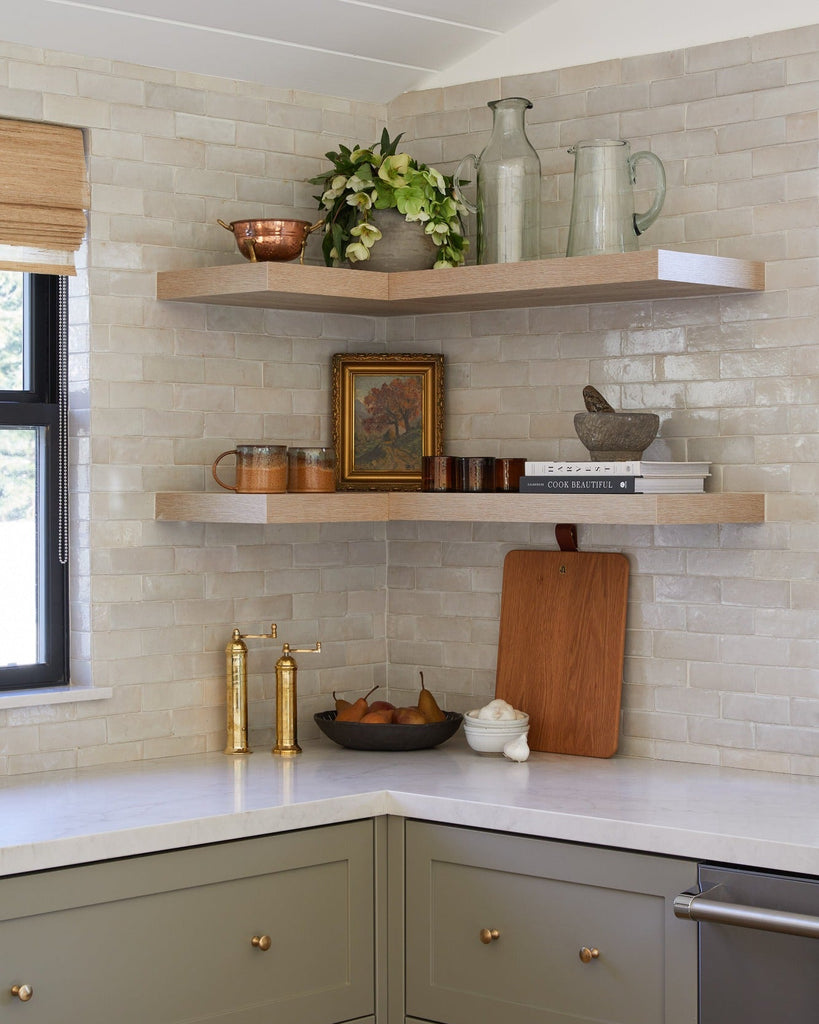 Brass Salt and Pepper Grinders styled on floating shelves in a kitchen setting