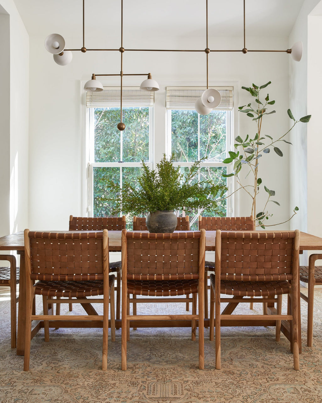 Woven leather dining chair with teak wood frame in saddle color, handcrafted in Bali