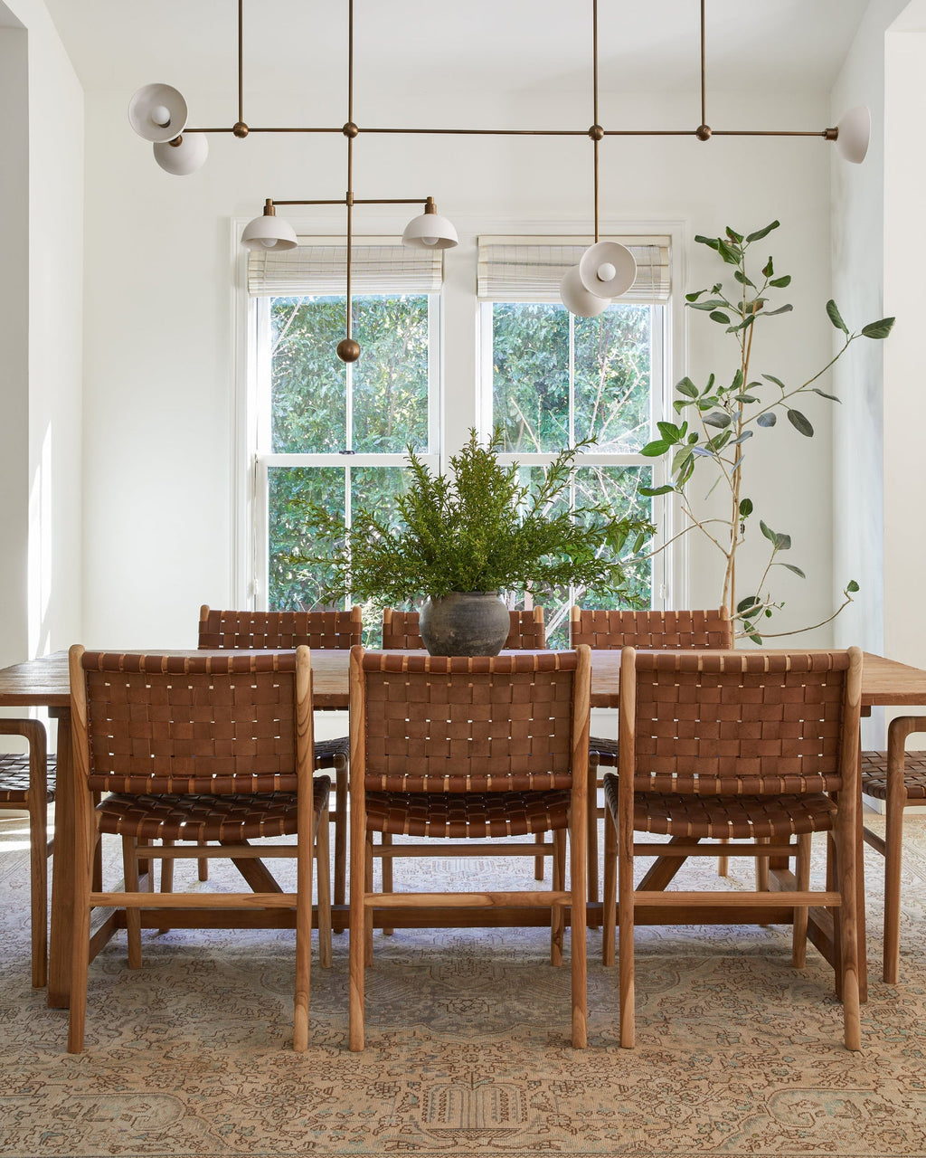 Woven leather dining chair with sculpted teak wood in saddle color, handcrafted and second quality sale