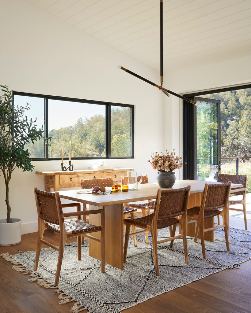 Styled photo of Woven Leather Dining Chair in a dining room setting with Live Edge Oak Dining Table