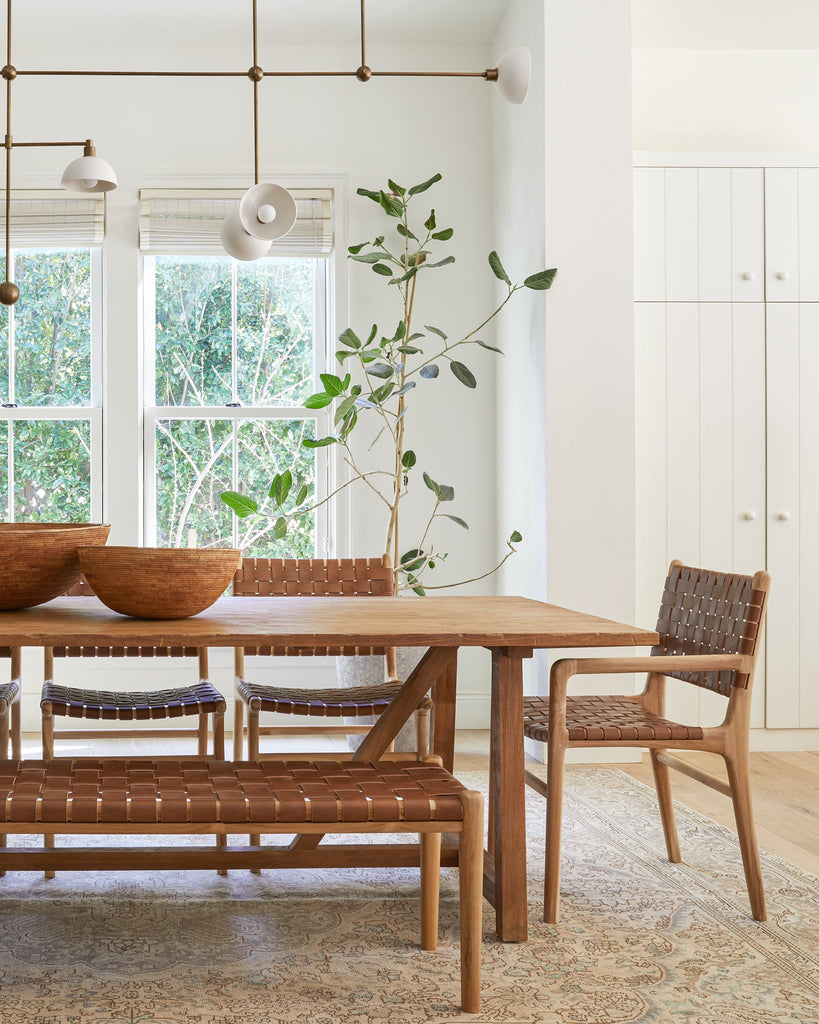 Styled photo with Saddle Woven Leather Dining Arm Chairs and Saddle Woven Leather Bench in modern dining room.