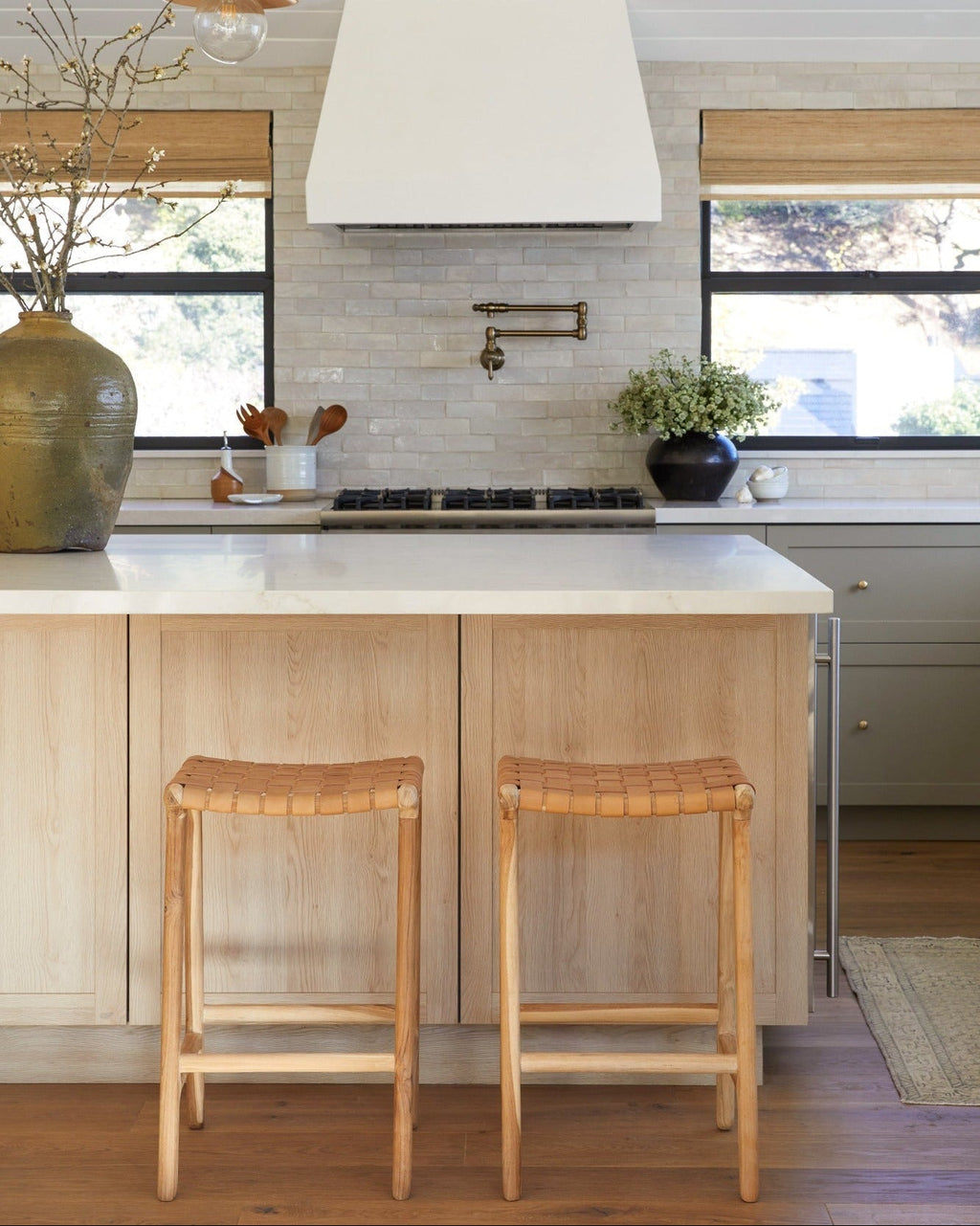 Backless woven leather counter stool with beige leather straps and teak wood frame
