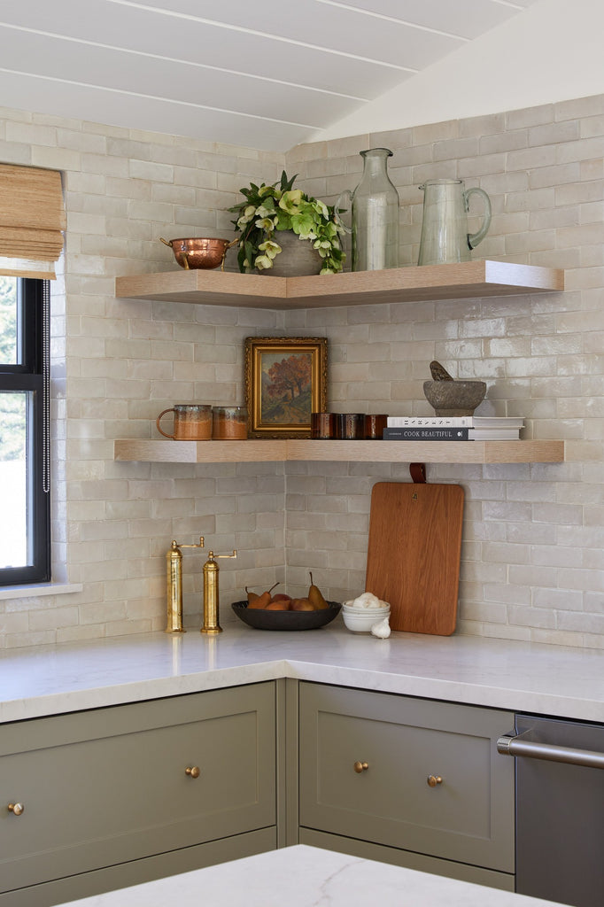 Brass Salt Grinder, Brass Pepper Grinder, Studio Inko Serving Board, Uzumati Tortoise Mugs, Ceramic Salt Bowls, and Antique Clay Pot styled on floating shelves in a kitchen setting. - Saffron and Poe