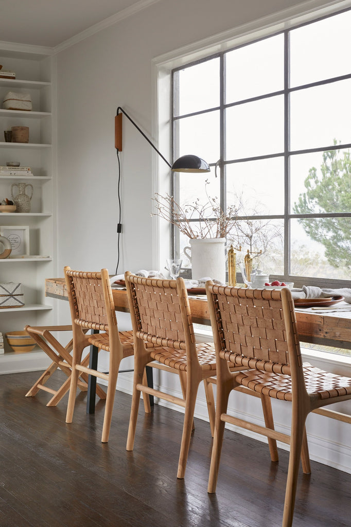 Woven Leather Dining Chair in Beige styled in a dining nook with Leather Folding Stool. - Saffron and Poe