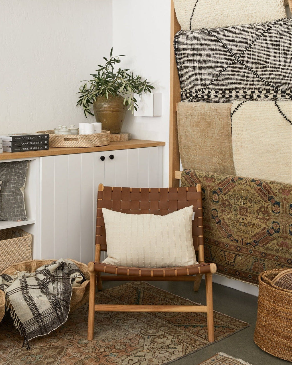 Woven leather lounge chair in saddle color with teak wood frame and natural matte finish