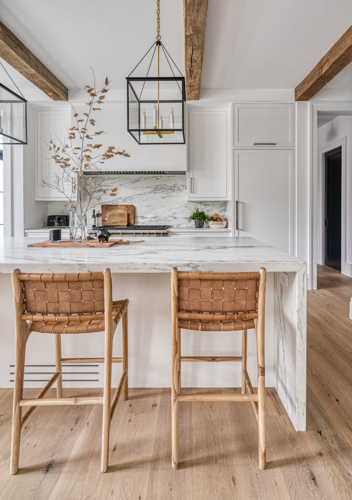 Styled Woven Leather Strap Counter Stool - Beige in a white kitchen. - Saffron and Poe