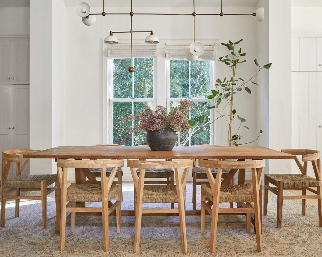 Woven Wishbone dining chair with braided rattan seat and curved teak frame handcrafted in Bali, second quality with natural wood grain imperfections.