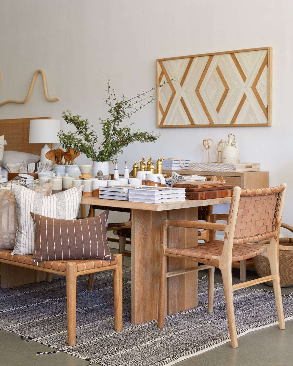 Beige woven leather strap dining chair with arms and teak wood frame, handcrafted with natural variations.