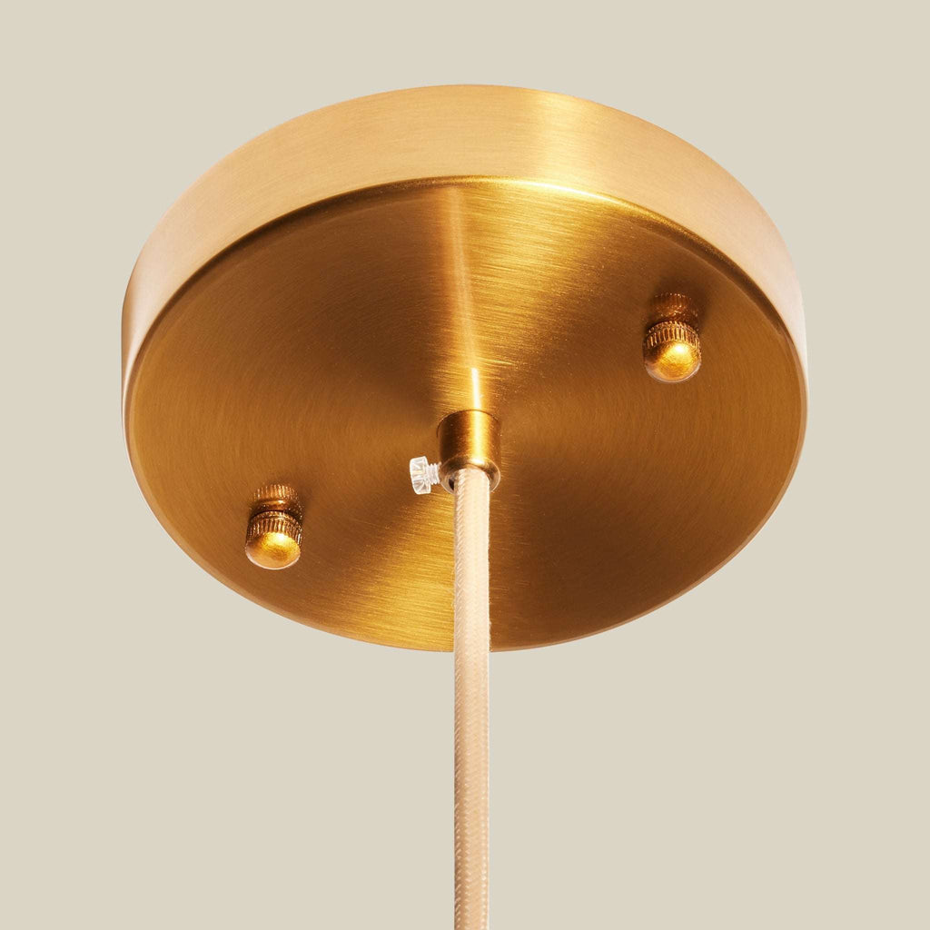 Brass ceiling light fixture on a neutral background