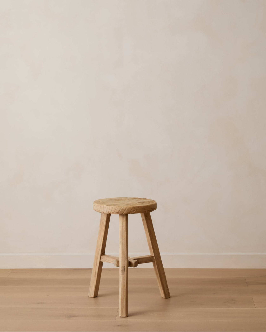 Vintage Chinese style round wooden stool with rustic patina and sturdy construction