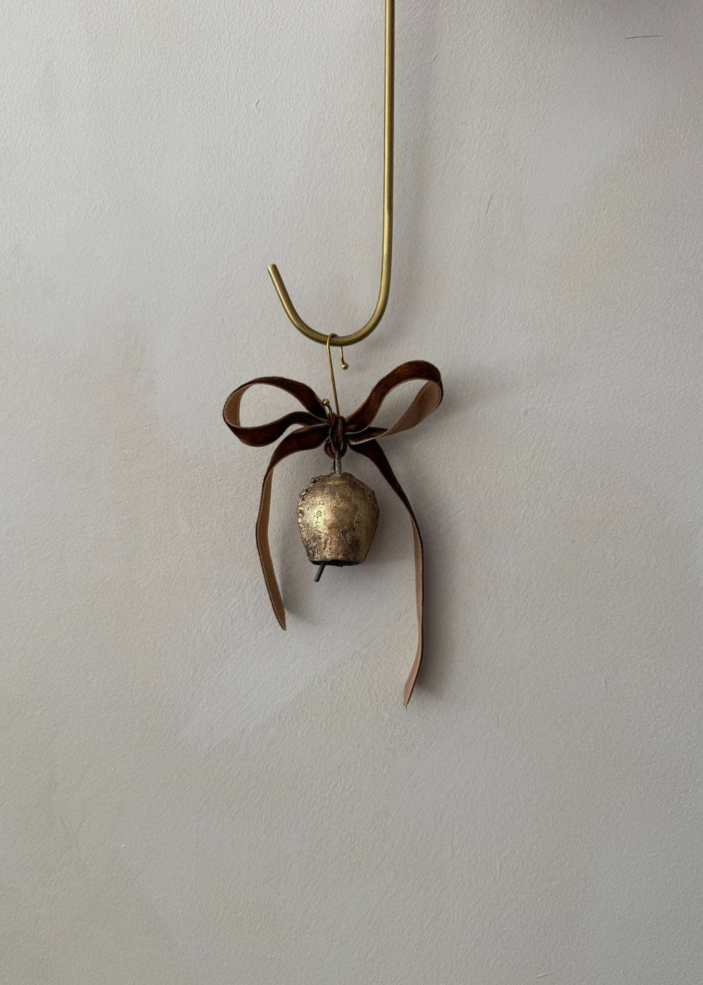 Vintage Bell Ornament with cinnamon velvet ribbon hanging on Christmas tree branch