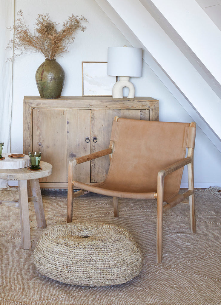 Vintage Reclaimed Elmwood cabinet with styled with a sling lounge chair, lamp and vintage vessel. Saffron + Poe