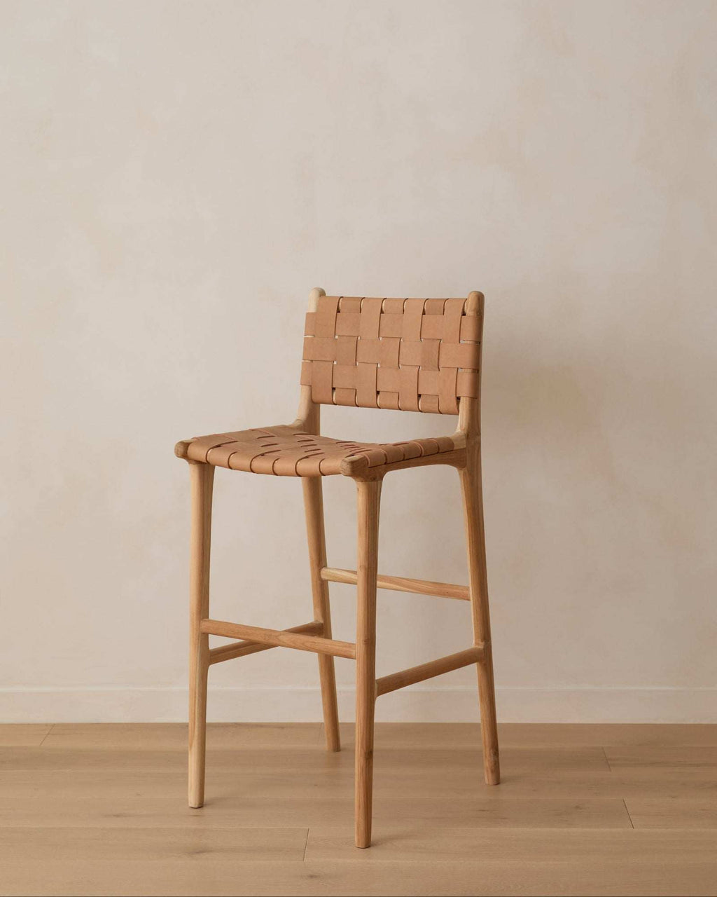 Beige woven leather bar stool with teak wood frame and handwoven leather straps