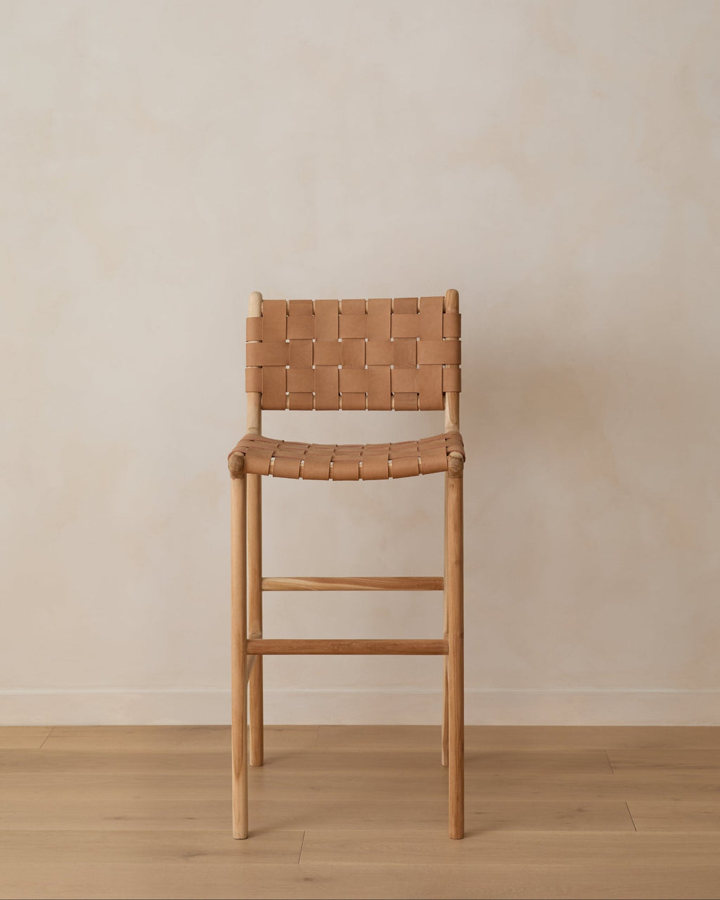 Beige woven leather bar stool with teak wood frame and handwoven leather straps