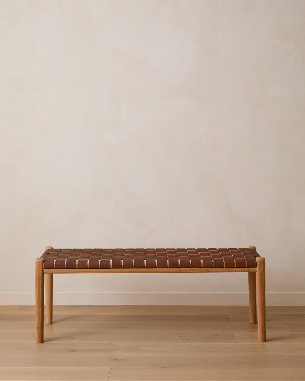 Handwoven saddle leather bench with Javanese teak wood frame in warm saddle color, second quality with natural leather variations