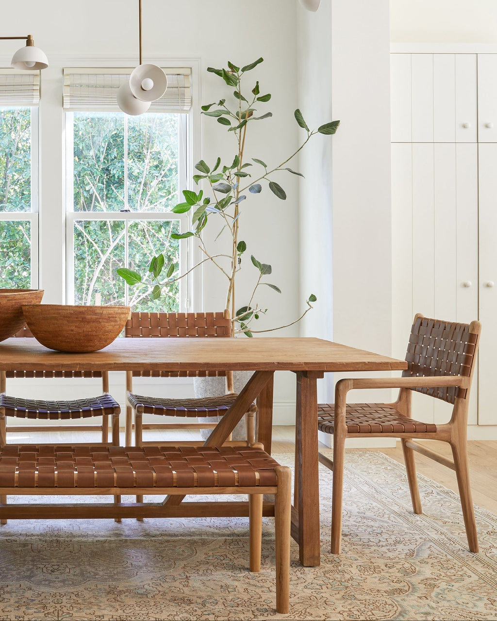 Handwoven saddle leather bench with teak wood frame, second quality with natural leather variations in dining room