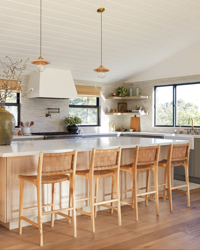 Woven Leather Counter Stool in Beige styled in modern oak and sage green kitchen, angle view