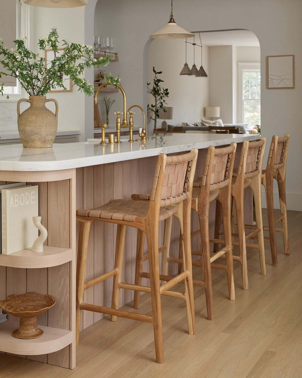 Beige woven leather counter stool with handwoven straps and teak wood frame