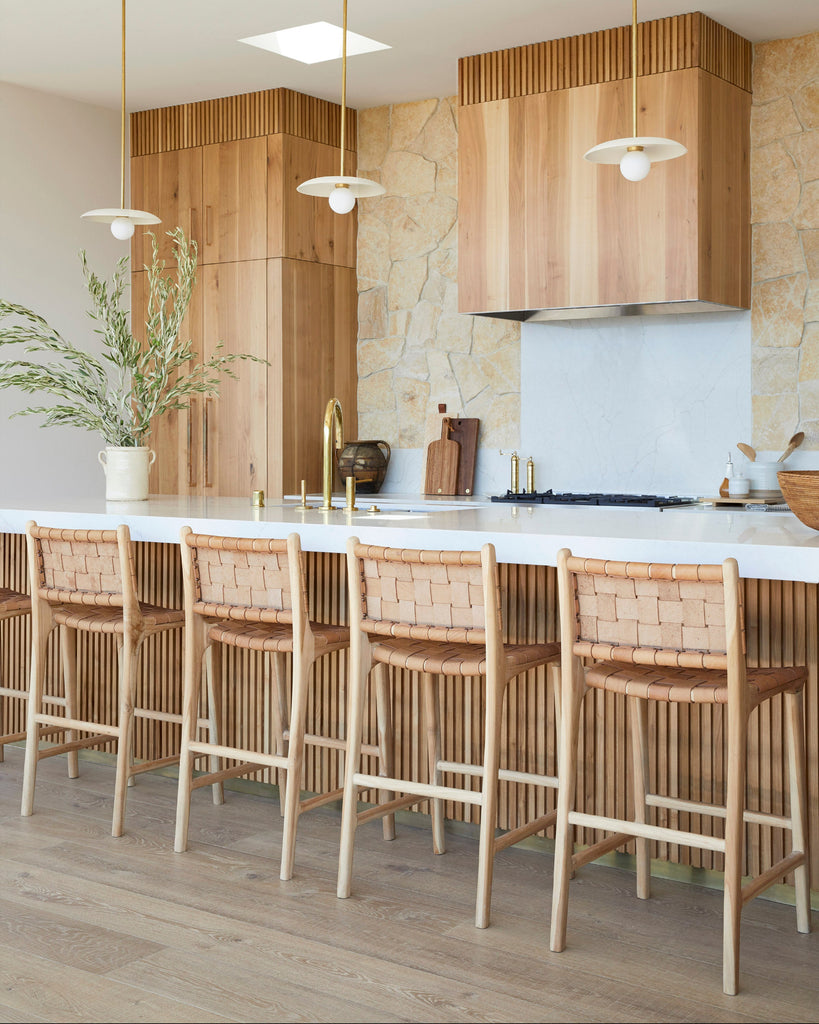 Woven Leather Counter Stools in beige in Modern kitchen with wooden cabinets, white countertops