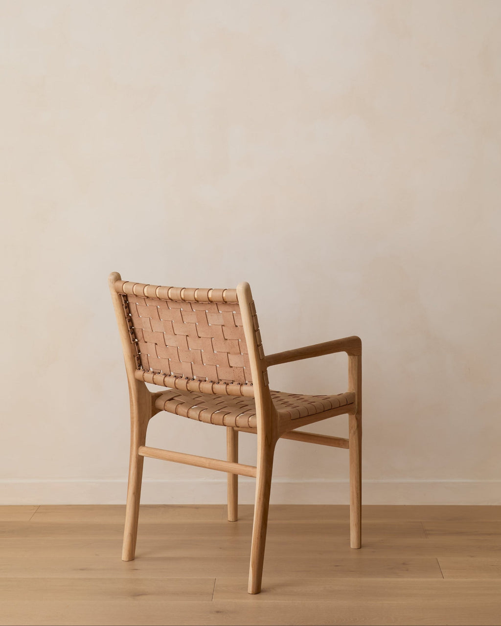 Beige woven leather dining arm chair with teak wood frame, handcrafted with natural leather variations, second quality sale item
