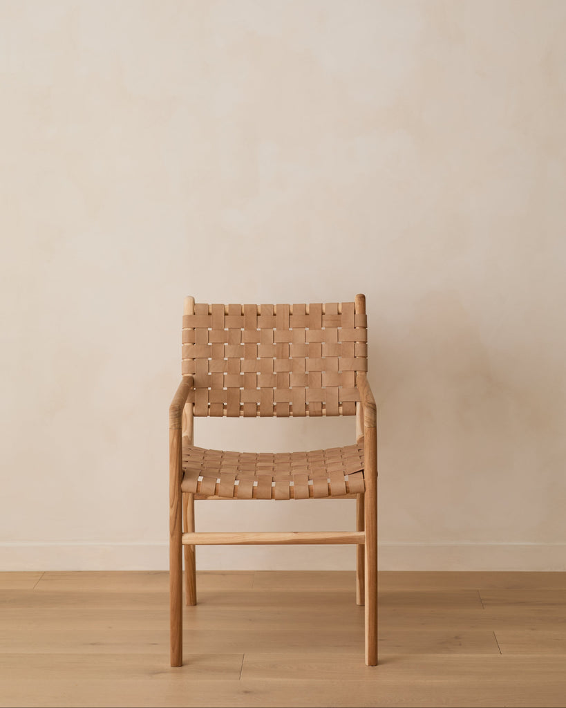 Woven Leather Dining Chair against lime washed wall and oak floor. Front View.
