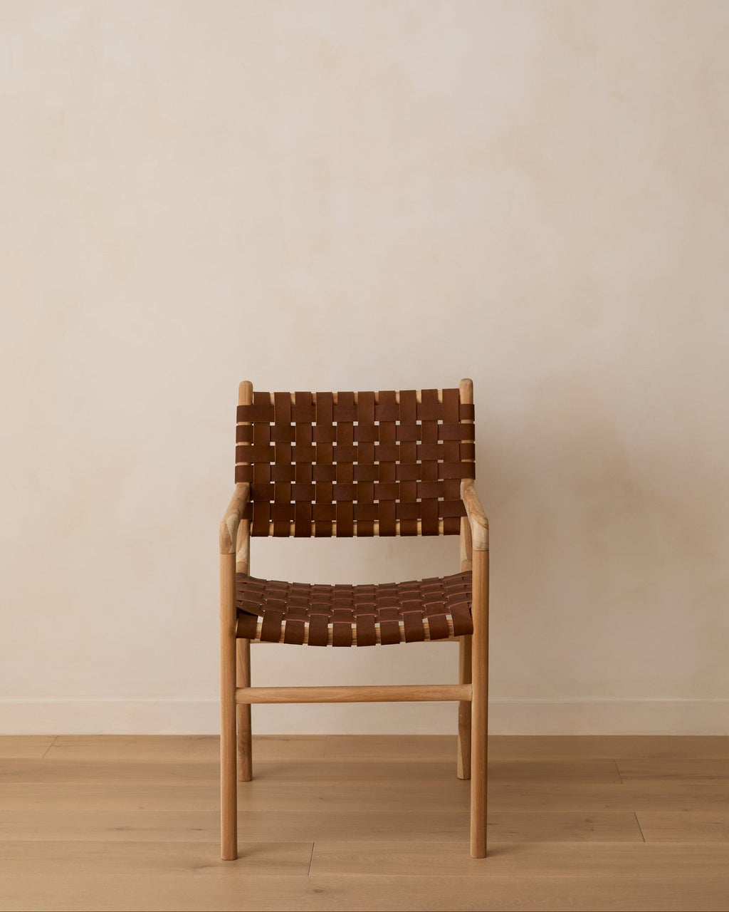 Woven leather dining arm chair in beige with teak wood frame, handcrafted in Bali, second quality with natural leather and wood variations
