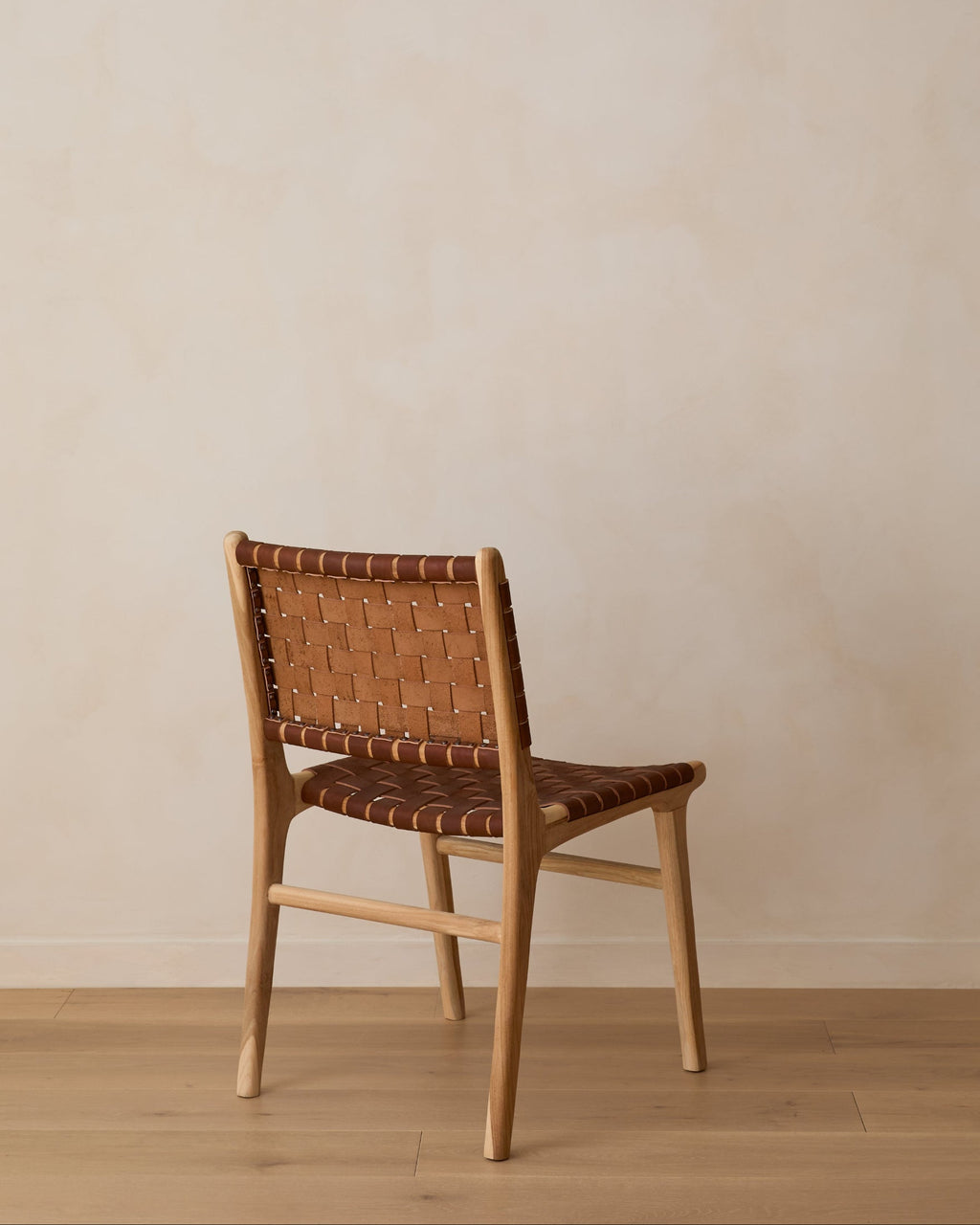 Woven leather dining chair with teak wood frame and saddle leather seat, second quality