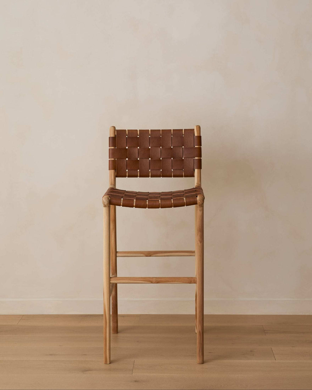 Woven Leather Bar Stool in saddle color with carved teak frame and leather straps