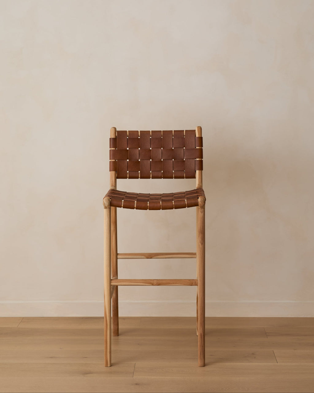 Woven leather bar stool in saddle color with teak frame, handcrafted and second quality with natural leather and wood variations