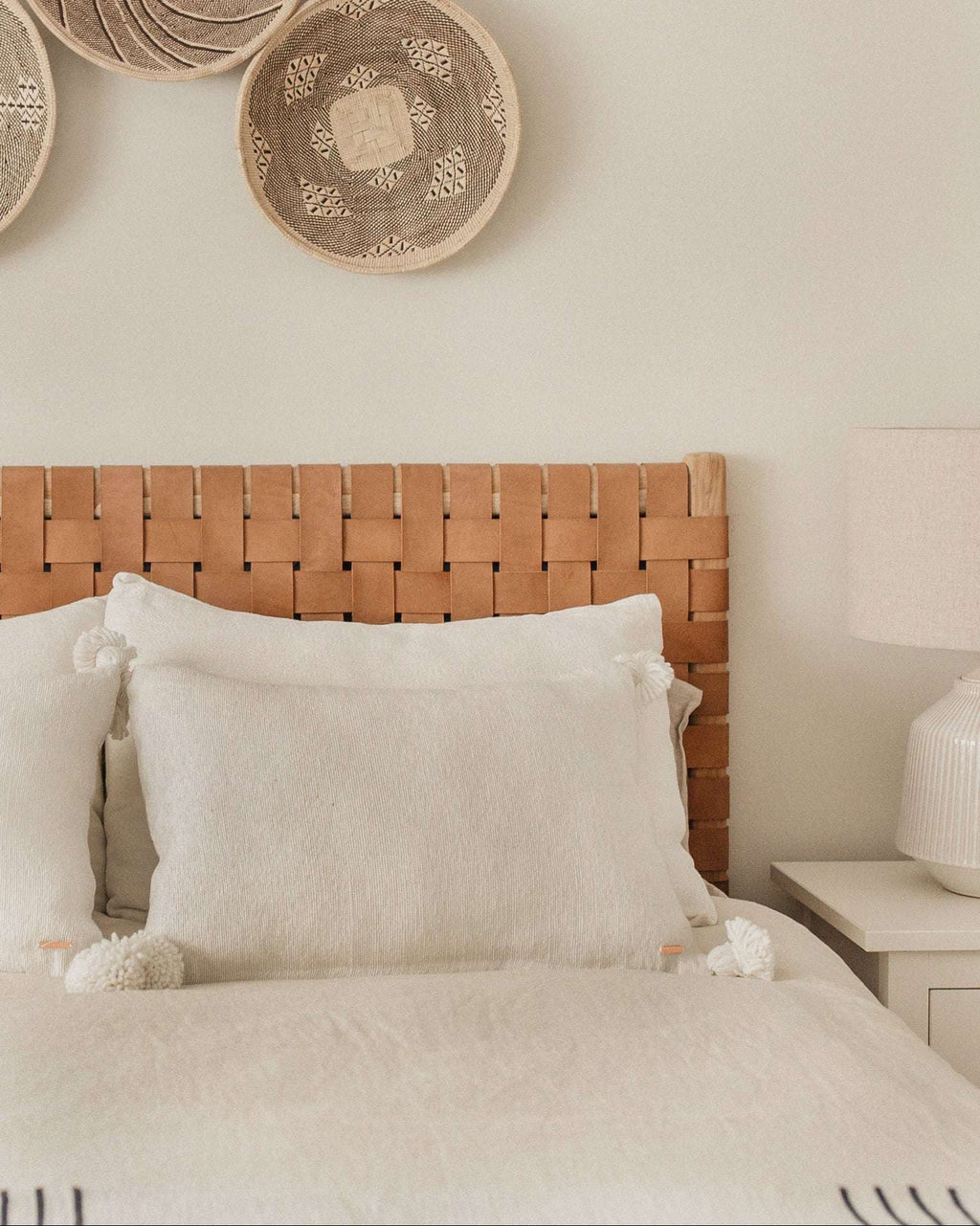 Woven leather strap headboard with beige leather and hand-carved teak frame in natural matte finish
